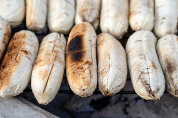 Grilled Thai banana at street food market in Thailand. Fried banana, delicious street food.