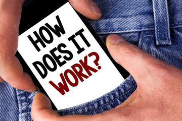 Word writing text How Does It Work Question. Business concept for asking about device or machine operation Tutorial written Mobile phone holding by man the Jeans background.