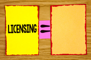 Conceptual hand writing showing Licensing. Business photo text Grant a license Legally permit the use of something Allow activity written Sticky Note Paper wooden background Equation Space.