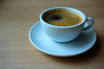 White Cup of Coffee on the Wooden Table.
