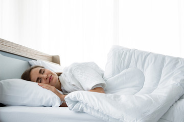 Young beautiful sleep in the bed at home.