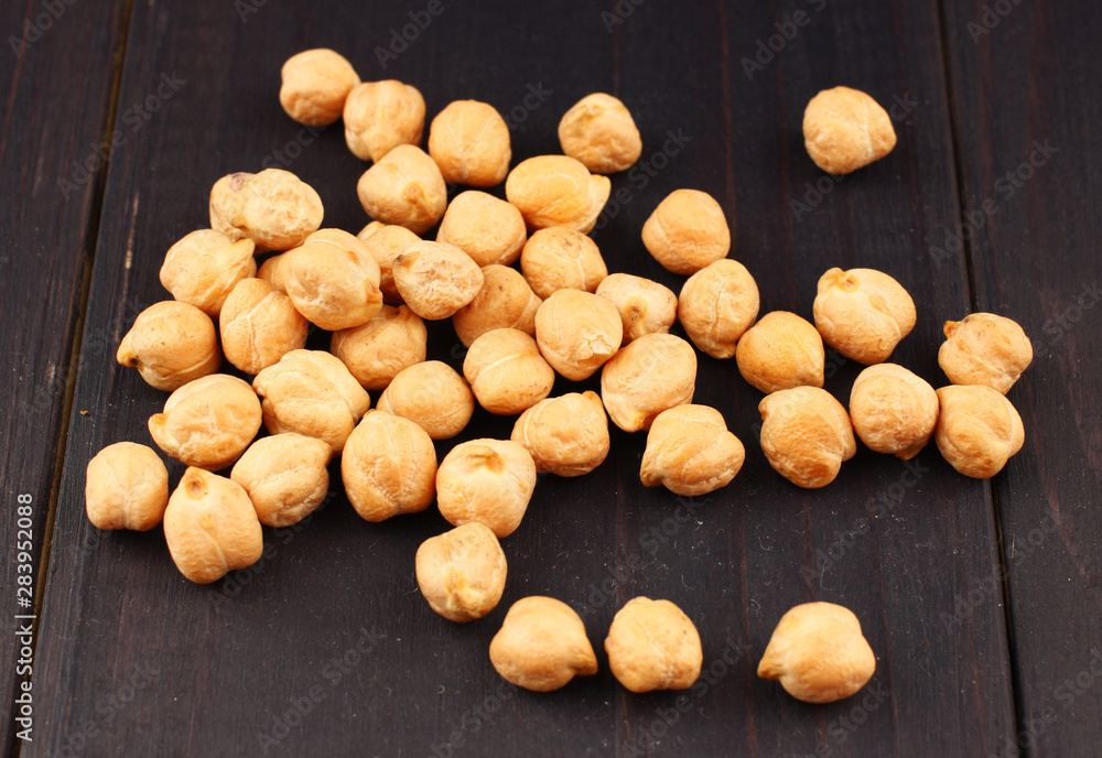 Poster chickpeas peas on a dark background closeup