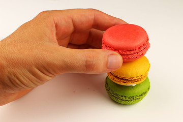 Macaroni colored pastry cookies on a white background