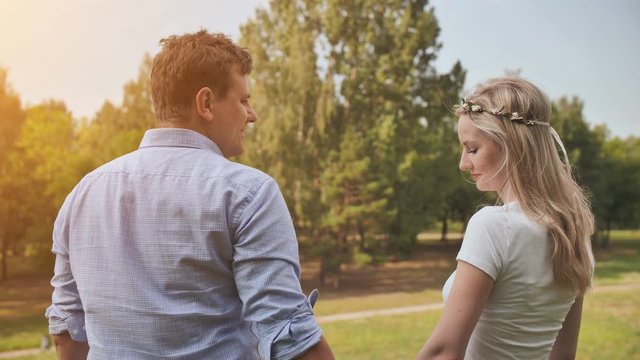 Young man and woman cuddling in the park