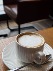 Cup of coffee latte on wood bar