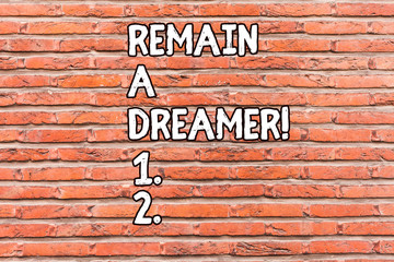 Fototapeta na wymiar Conceptual hand writing showing Remain A Dreamer. Concept meaning they spend lot of time thinking about and planning things Brick Wall art like Graffiti motivational written on wall