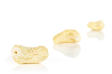Group of three whole unsalted beige cashew isolated on white background