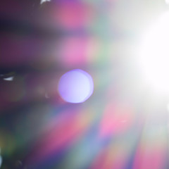 Abstract image of the sparkling sunrays. The visible light of the sun, in the colors red, orange, yellow, green, blue, indigo and violet. Bright and shiny beams of light.