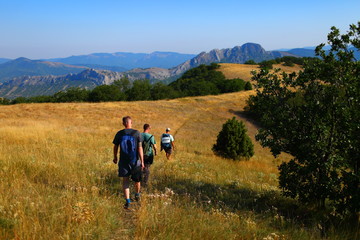 Fototapeta na wymiar Tourists walking along the trail in the mountains