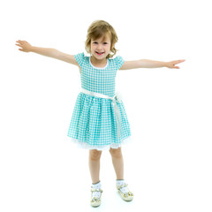 A cheerful little girl is dancing.