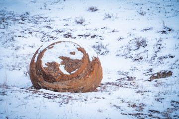 Large red boulders at Red Rock Coulee, Alberta, Canada in the evening on a cold winter day