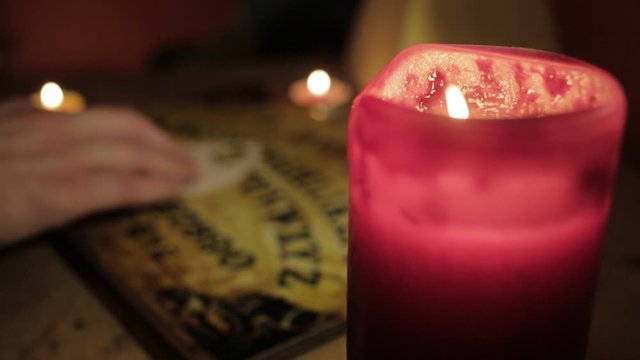 White Male using Ouija Board out of focus