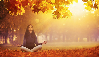 Yoga Woman Meditating In Autumn Park.  Fall Scene