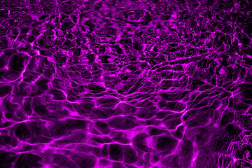 Ripple water in swimming pool with sun reflection in neon purple color.