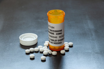 Prescription bottle with backlit Oxycodone tablets. Oxycodone is a generic prescription opioid. A concept of the opioid epidemic crisis