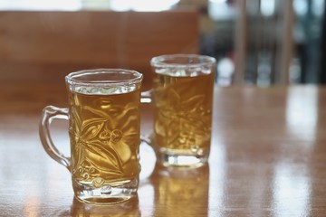 Hot tea in a glass on a wooden table