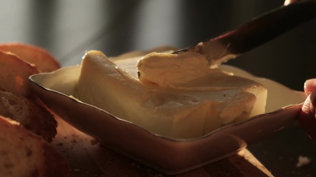 Cheese butter or margarine with knife, slow motion