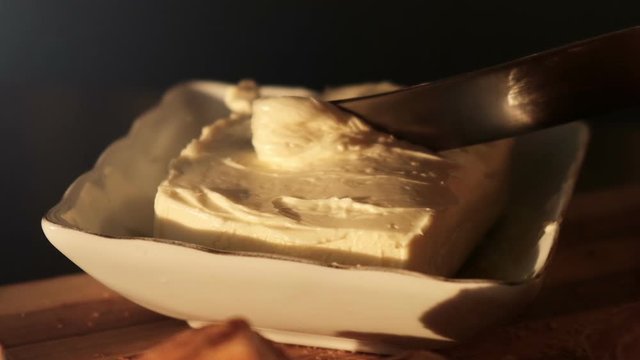 Closeup video of a butter knife and butter, slow motion
