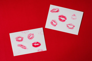 Women's lips lipstick kiss print set for Valentine's Day and love collection on white paper on red . The shape of the lip makeup gloss sample smear.