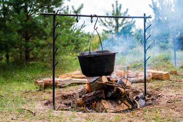cooking at the stake in a cauldron, fire and smoke