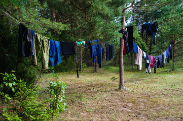 Fototapeta na wymiar Rope with wet clothes in the open air in camp