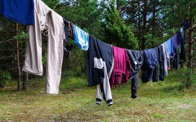 Rope with wet clothes in the open air in camp