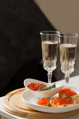 Red caviar on baguette canape and champagne