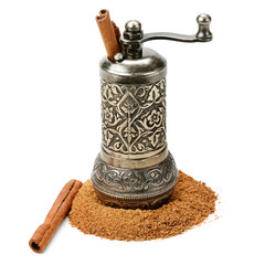 Cinnamon and manual grinder isolated on white background.