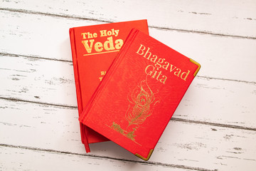 Holy Bhagavad gita and The Holy Veda the oldest scriptures of Hinduism on wooden textured background