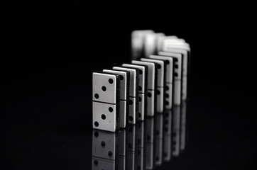 row of dominoes on black background