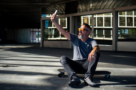 Skater taking a selfi on a skateboard