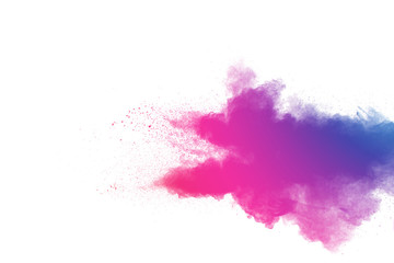Abstract multi color powder explosion on white background.Freeze motion of dust particles splash.
