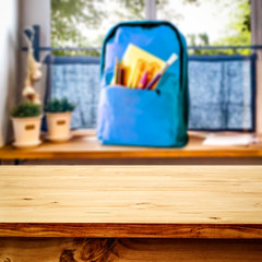 Schoolbag on windowsill and table background for products and decoration.