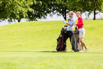 Golfing couple at golf field