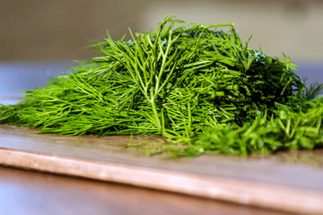 green dill from the garden on the Board cut with a knife