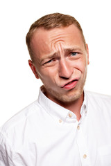 Fototapeta premium Handsome young blond man in a white shirt, isolated on a white background