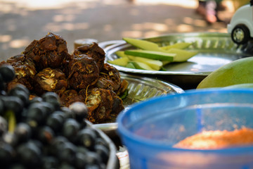 Stock photo of fresh homemade raw tamarind ball kept in steel plate for sale in Indian village...