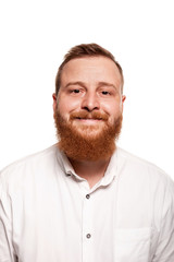 Fototapeta premium Portrait of a young, chubby, redheaded man in a white shirt making faces at the camera, isolated on a white background