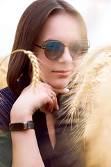 Portrait of beautiful young woman in wheat field