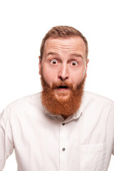 Fototapeta premium Vertical shot of stupefied stunned shocked young male keeps mouth widely opened, being surprised and very emotional, expresses great surprisment.