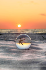 Beautiful sunset on the beach in Slowinski National Park near Leba, Poland. View of a starfish...