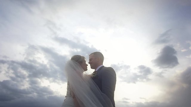 Cinematic tilt up of a bride and groom dancing together at their elopement in the mountains
