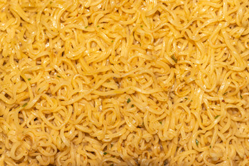 Close up noodles with vegetable in a bowl. Top view boiled noodle background and texture.