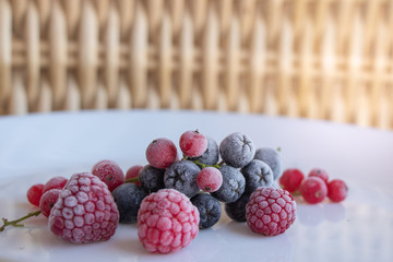 Frozen berries of ripe raspberry and red currant