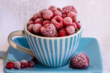 Frozen berry ripe raspberries and red currants in a Cup