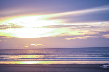 Naklejka na ściany i meble starting life sun set on the beach miracle colorful orange light