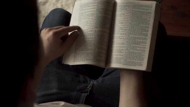 Depressed man frustrated by religion, throws his bible book away