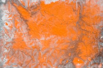 orange watercolor painted on creased paper background texture