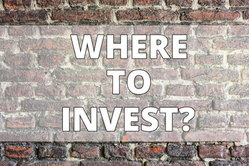 Fototapeta premium Writing note showing Where To Investquestion. Business concept for Right Place Stock Share to spend your savings in Brick Wall art like Graffiti motivational call written on the wall