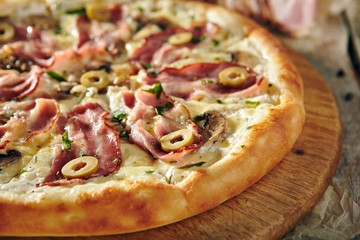 Pizza Restaurant Menu - Delicious Fresh Pizza with Bacon and Olives. Pizza on Rustic Wooden Table with Ingredients